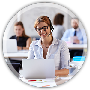 office woman at a desk working weaaring a headset smiling